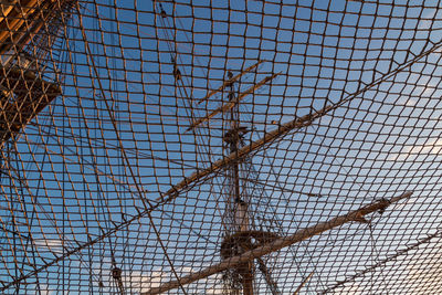 Low angle view of chainlink fence against sky
