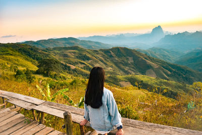 Rear view of woman looking at mountains