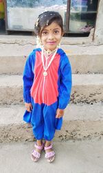 Portrait of girl wearing jewelries standing outdoors