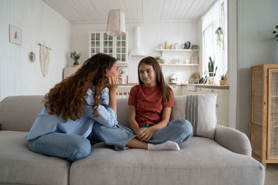 Portrait of happy family sitting on sofa at home