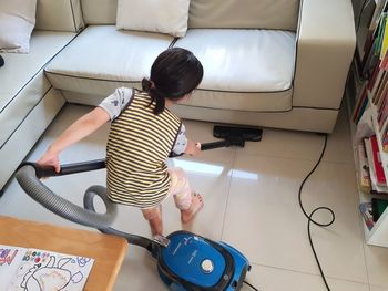 High angle view of child playing on floor at home