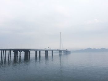 Scenic view of bridge over sea against clear sky