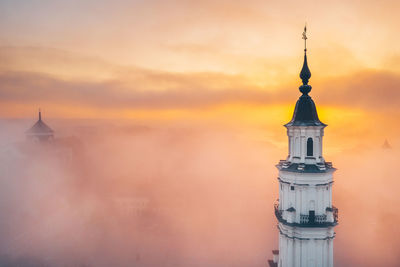 Tower of building against sky during sunset