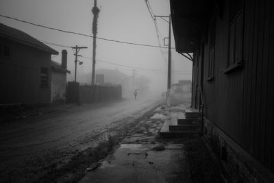 Street amidst buildings in city during rainy season