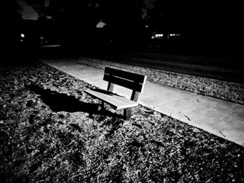 High angle view of empty bench in park at night