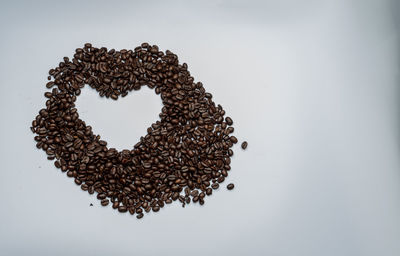 High angle view of heart shape on table against white background