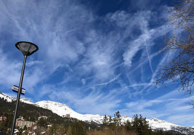 Low angle view of snowcapped mountains against sky