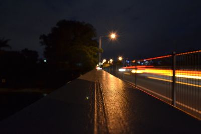 Cars moving on illuminated road in city at night