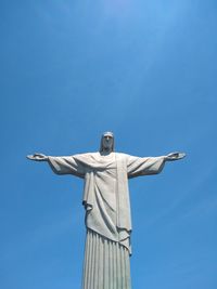 Low angle view of statue against blue sky