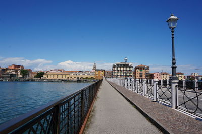 Street leading towards buildings in city