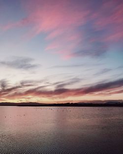 Scenic view of sea against romantic sky at sunset