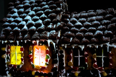 Illuminated lanterns hanging for sale at market stall