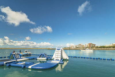 Inflatable slide for water sports, jet ski and motor boating in hamakawa fishing port in okinawa.