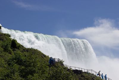 Low angle view of waterfall against sky