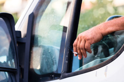 Reflection of man in car mirror