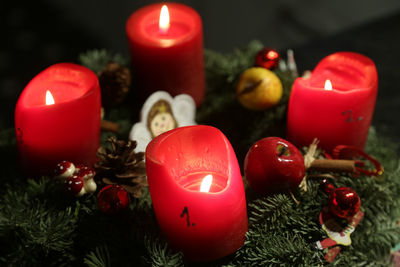 High angle view of lit candles on christmas decoration