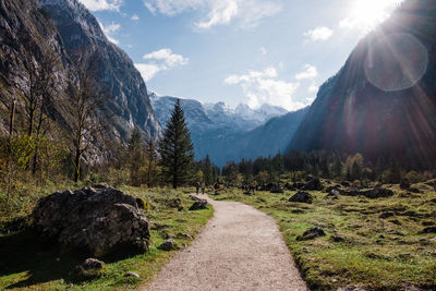 Hiking path in schönau against sky with mountains in the background.