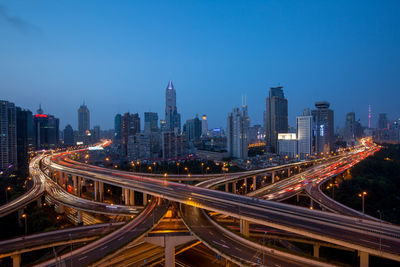 High angle view of light trails on road in city