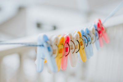 Close-up of multi colored clothespins hanging on clothesline