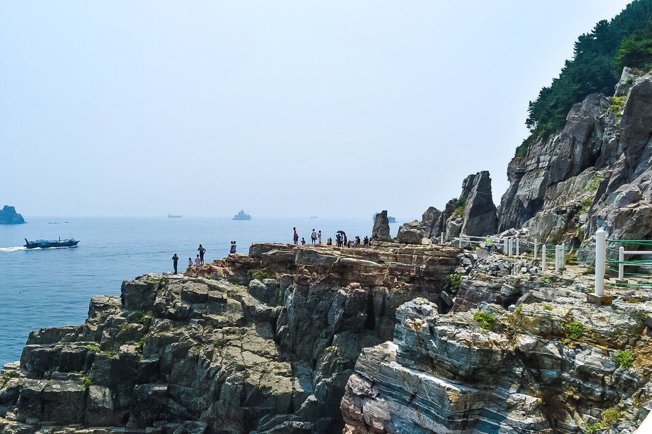 sea, water, rock - object, horizon over water, rock formation, clear sky, tranquil scene, cliff, scenics, tranquility, nature, tourism, mountain, blue, beauty in nature, sky, day, geology, outdoors, rocky, rock, non-urban scene, physical geography, rocky mountains, coastline, vacations