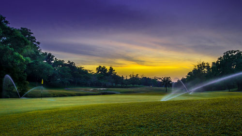 Scenic view of field against sky during sunset