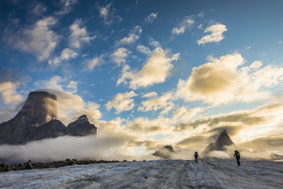 Climbers set up tent on glacier below mt. loki, baffin island.