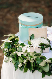 Close-up of white flowering plants in jar on table