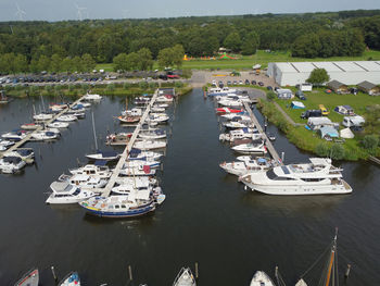 High angle view of sailboats moored in river