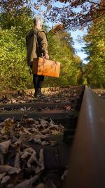 Woman walking on railroad track