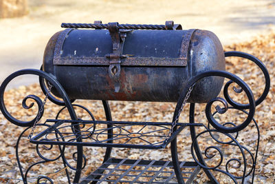 Metal grill with twisted wrought iron curly handles.
