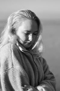 Portrait of young woman sitting outdoors