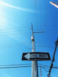 Low angle view of road sign against sky