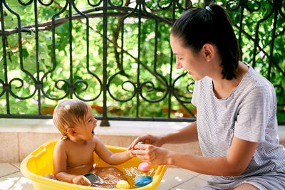 Mother and son sitting outdoors