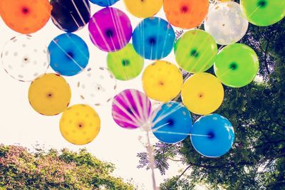 Low angle view of balloons against sky