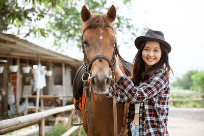 Portrait of young woman riding horse