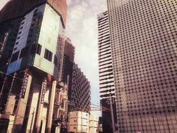 Low angle view of modern buildings in city against sky