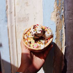 Close-up of hand holding ice cream