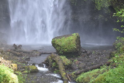 Scenic view of waterfall against sky