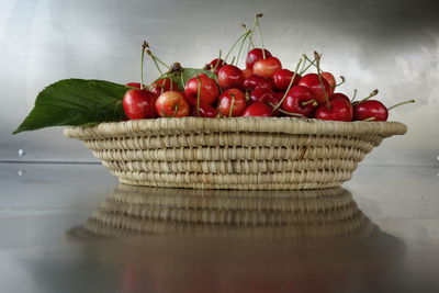 Cherries in wicker basket on table