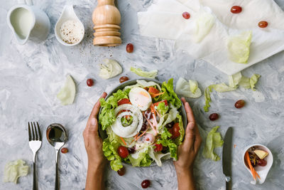 Directly above shot of person holding breakfast at table