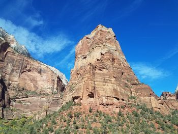 Low angle view of rock formations against blue sky