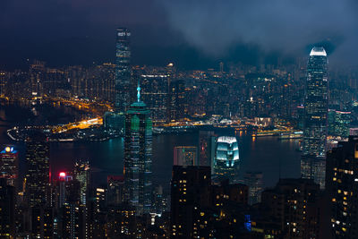 Illuminated cityscape against sky at night