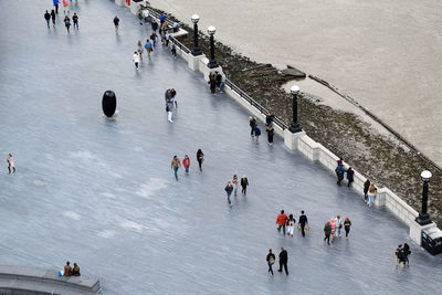 High angle view of people walking on snow covered city