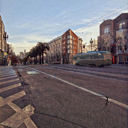 View of city street and buildings against sky