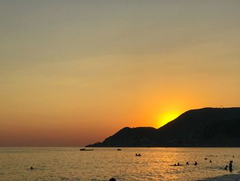 Scenic view of sea against orange sky