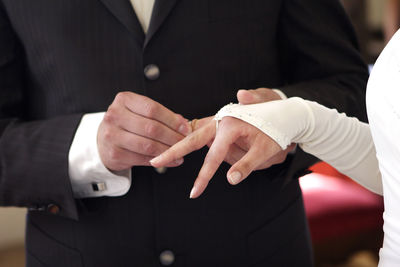 Midsection of businessman giving handshake