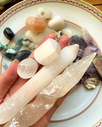Close-up of hand holding ice cream in plate
