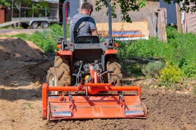 Rear view of man working on field