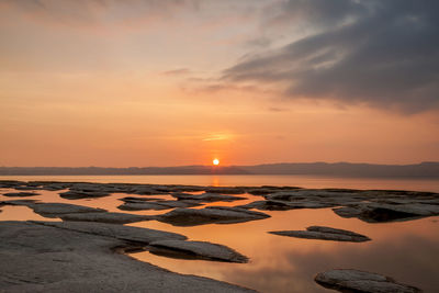 Scenic view of sea against romantic sky at sunset