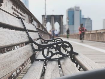 Close-up of bicycle on bench in city